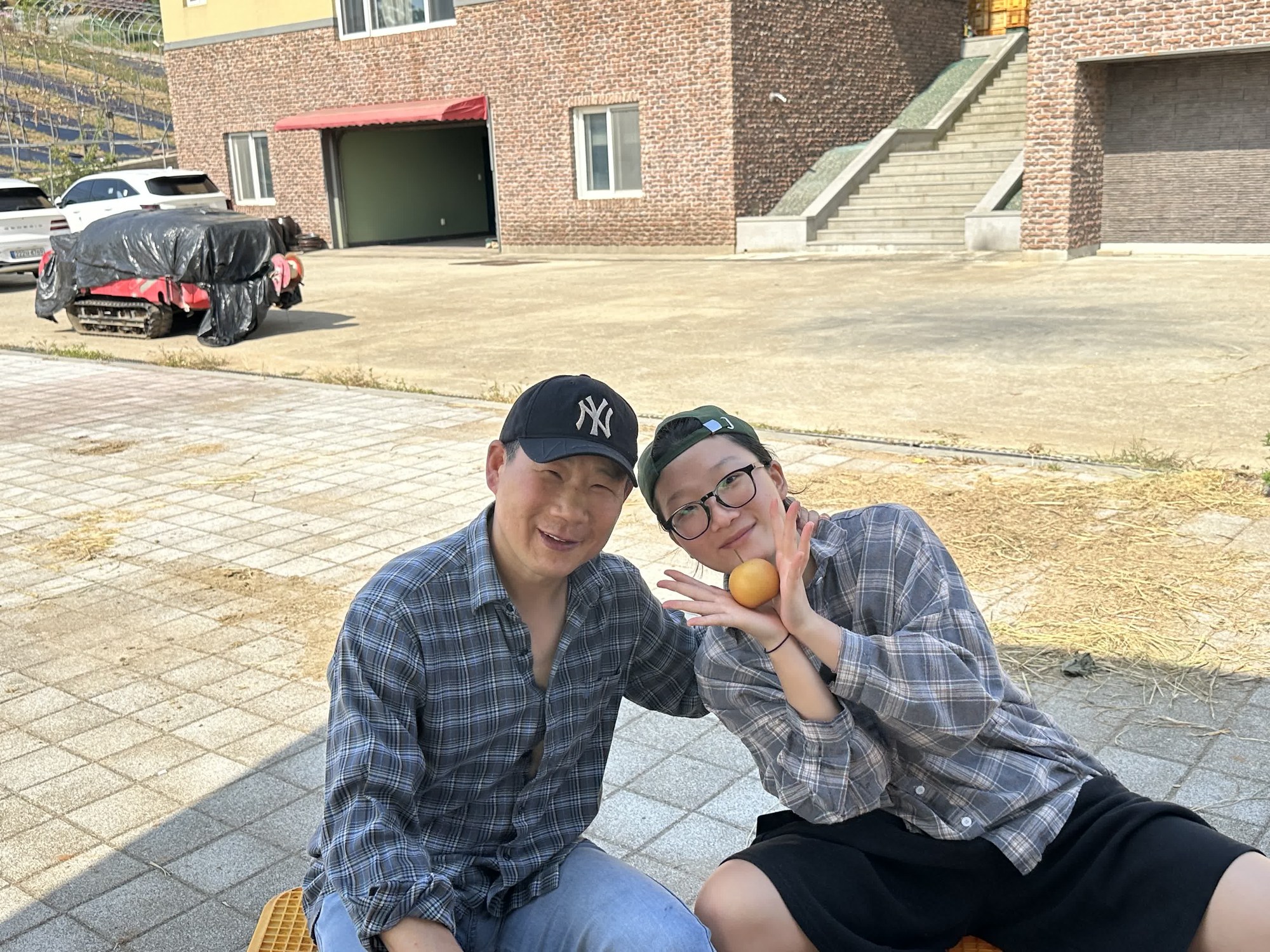 배를 볼에 대고 장난스럽게 웃는 두 사람